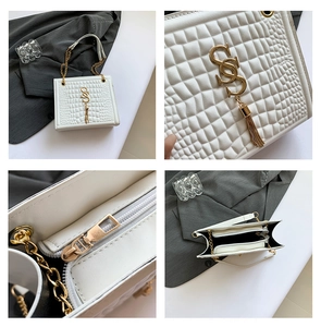 Detail der weißen Umhängetasche mit goldener Hardware, Kettenriemen und Quaste