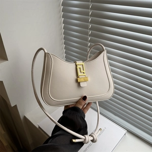 Minimalist cream shoulder bag with golden Greca buckle and sleek curved leather design