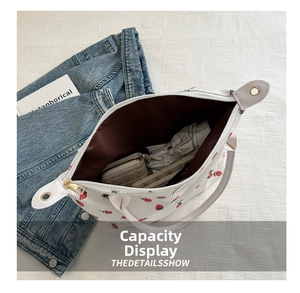 Top view of large capacity tote bag interior with strawberry print and personal items