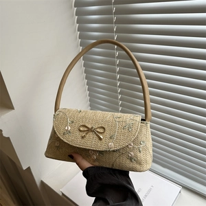 Straw baguette bag with floral embroidery and gold bow buckle, stylish summer shoulder bag