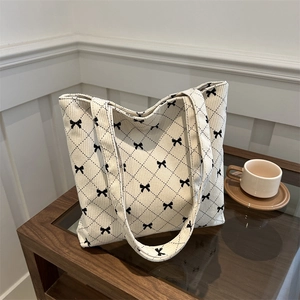 Borsa tote in velluto a coste beige con ricami a fiocco nero e trapuntatura a rombi
