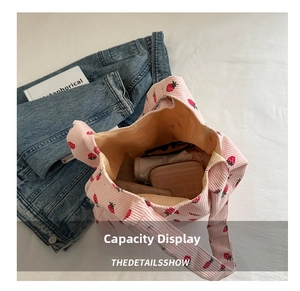 Pink corduroy strawberry tote bag showing large capacity with daily essentials