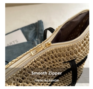 Close-up of golden metal zipper and smooth texture on a woven straw tote bag