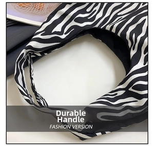 Close-up of zebra print canvas hobo bag with thick fabric texture and seamless handle
