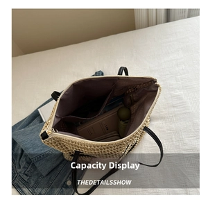 Detail view of woven straw tote bag interior showing large capacity and purple lining