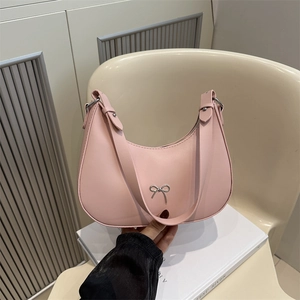 French style half-moon shoulder bag in pink leather with silver metal bow accessory