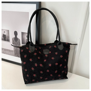 Detail of strawberry print corduroy tote bag showing fabric texture and zip closure