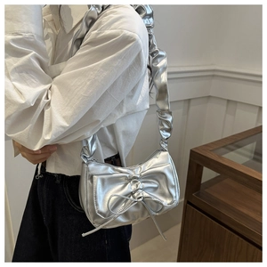 Silver metallic underarm bag featuring ruffled shoulder straps and bow knot detail