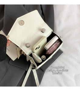 Internal view of a white quilted crossbody bag showing ample space for daily essentials