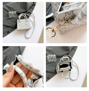Detail view of mini crossbody bag showing golden hardware and M-pattern leather texture