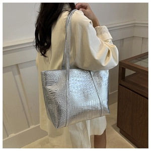 Silver metallic faux-croc tote bag shown on a model for a stylish casual daily look