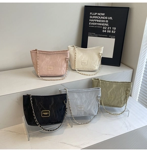 Detailed display of five colorful pleated bucket bags with gold logos and chain straps