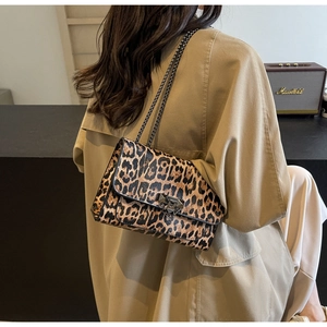 Detail of leopard print crossbody bag with metallic chain strap and square lock