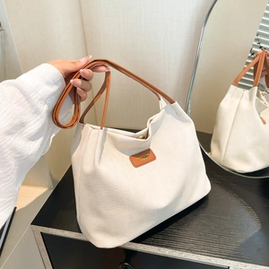 Large contrast color canvas bucket bag with waffle texture and brown leather straps
