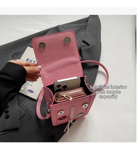 Pink crossbody bag with spacious interior for smartphone and wallet, close-up view