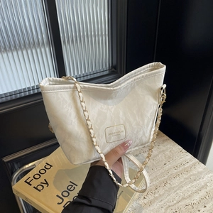 Chic beige tote bag with marble texture and golden chain strap for modern women