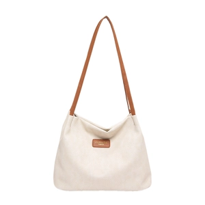 Minimalist beige woven hobo tote bag with brown leather handles and logo detail