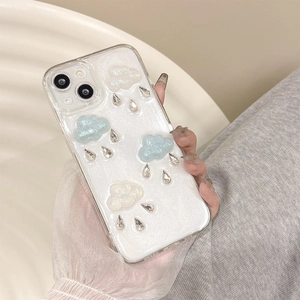 Detailed view of 3D resin clouds and teardrop rhinestones on a pearly white iPhone case