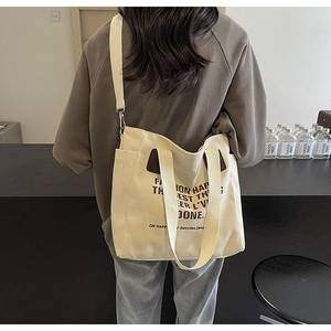 Détail du grand sac cabas en toile avec bandoulière réglable et poignées contrastées