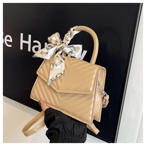 Chic quilted crossbody bag in beige leather texture with decorative silk scarf detail
