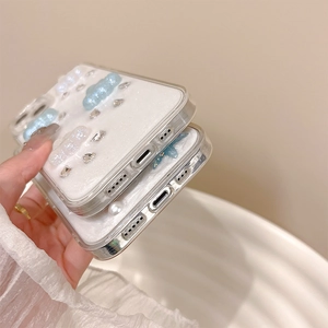 Detail showing precise charging port cutouts on cloud and rhinestone iPhone case