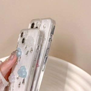 Close-up of 3D cloud and raindrop rhinestones on transparent iPhone phone case
