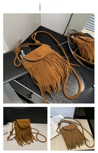 Close-up of the retro brown fringe crossbody bag with soft suede texture and tassel details