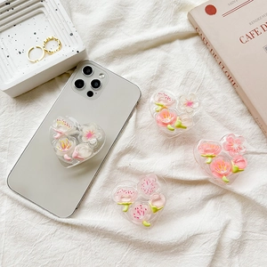 3D heart shaped phone grip with cherry blossom flower inside on white fabric