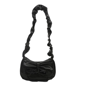 Fashionable black glossy underarm bag with ruffled strap and bow detail for women