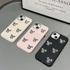 Detailed view of silicone phone cases featuring 3D silver metallic bear decorations