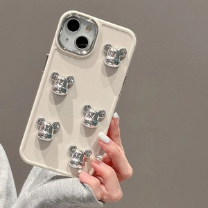 Detail shot of five 3D metallic silver bear figurines on a cream iPhone silicone case