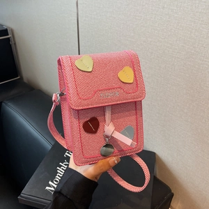 Pink woven crossbody bag featuring colorful heart patches and fashion embroidery charm