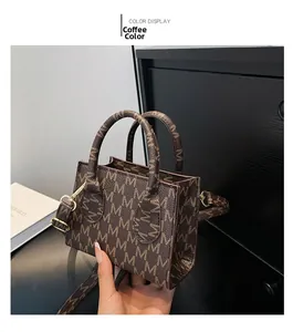Detail of coffee brown mini handbag with M-pattern monogram and gold-tone hardware