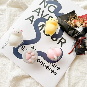 Set of four cute 3D silicone cat-themed pop-out phone grips on aesthetic background