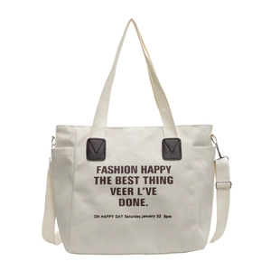 Retro canvas tote bag in off-white with black lettering and adjustable shoulder strap