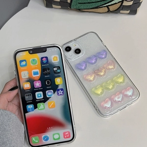 Détail de coque iPhone transparente avec des cœurs pailletés 3D en dégradé sur une grille