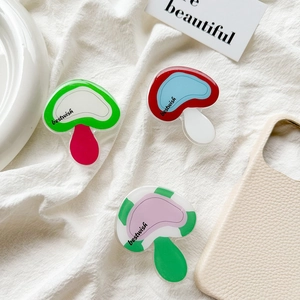 Detail of acrylic mushroom phone grip holders with bestwish text on leather cases