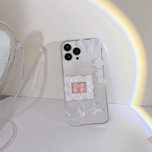Detailed view of luxury 3D floral iPhone case with pearls, butterflies and bow decorations