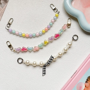 Colorful pearl beaded phone charms with bows and hearts in pastel aesthetic styles