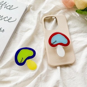 Close-up of mushroom phone grip on beige lychee leather case with floral decor