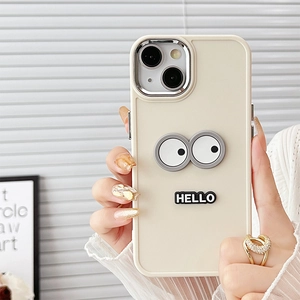 Detail of creamy white silicone phone case with large cartoon eyes and HELLO text