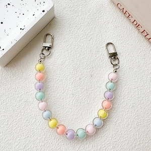 Macro shot of colorful macaron pearl beads phone charm with silver lobster clasps