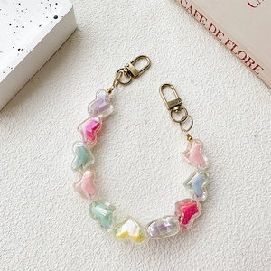 Detail of colorful resin heart beads phone strap with golden lobster clasps