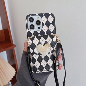 Crossbody iPhone case with black and white checkerboard pattern and heart coin purse