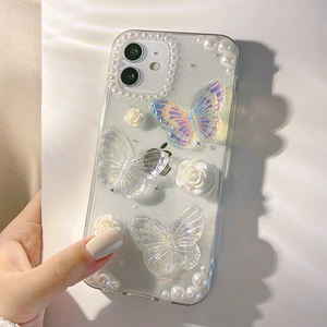 Detail view of transparent iPhone case with 3D butterflies, resin roses and pearls