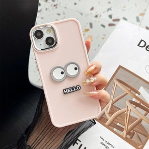 Detailed view of pink silicone iPhone case with 3D cartoon eyes and Hello lettering