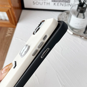 Detail of cartoon eye phone case with premium metallic side buttons and matte silicone texture