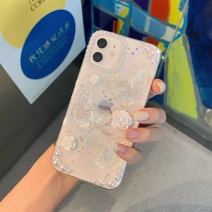 Detailed view of pink glitter iPhone case featuring 3D butterflies and white roses