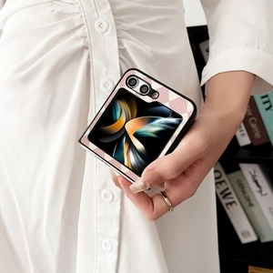 Close-up of pink checkered leather phone case for Samsung Z Flip series held by a model