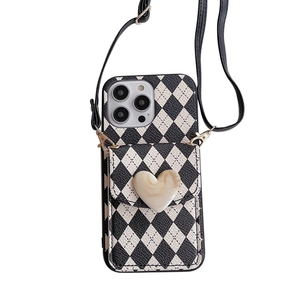 Crossbody iPhone 16 Pro Max case with black and white diamond pattern and heart card holder